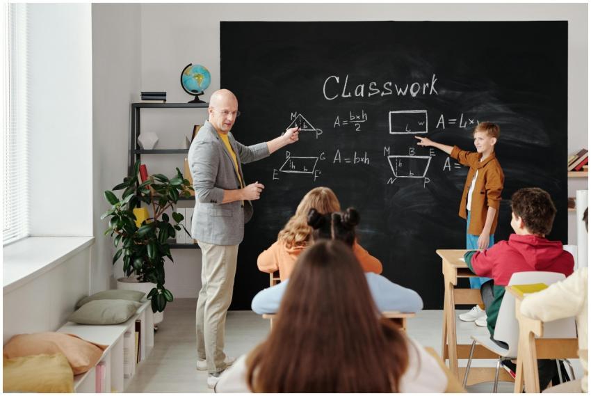 A teacher and students in a classroom during a geo