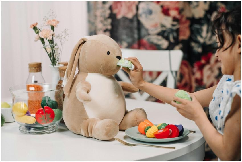 A child enjoying playful interaction with a plush