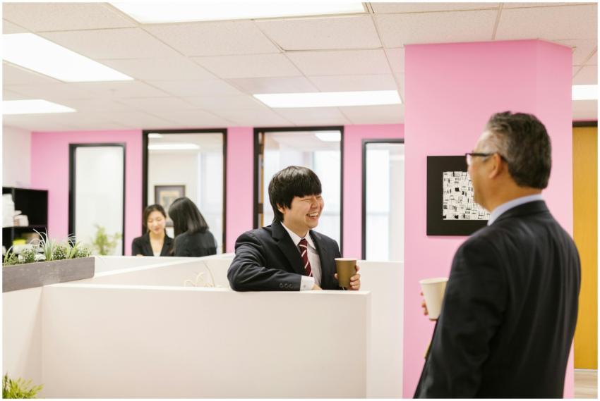 Colleagues in business attire enjoy a coffee break