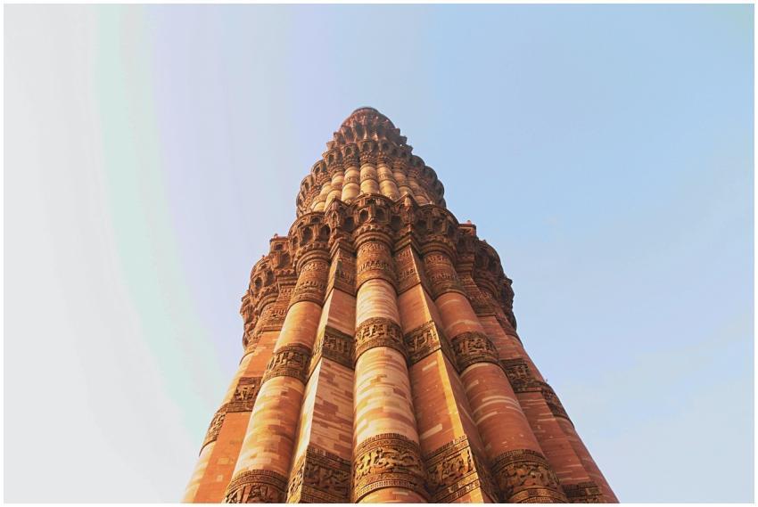 Majestic view of Qutub Minar against a clear blue