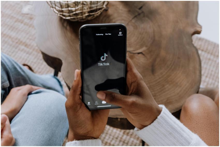 Close-up of hands holding a smartphone displaying