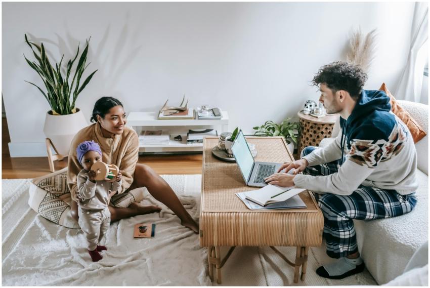 A mother and father engage with a toddler in a com