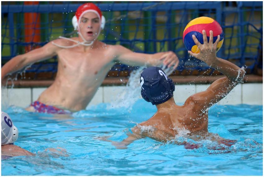 Competitive water polo game with athletes in actio