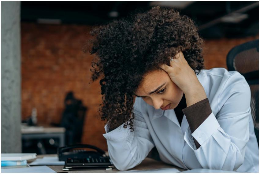 A woman in an office appears stressed while review