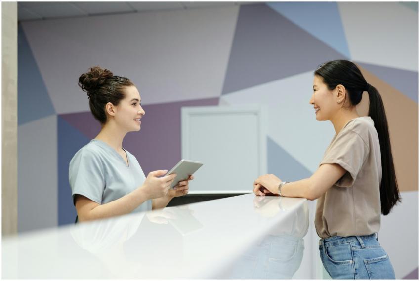 A receptionist and a visitor engaging at a modern