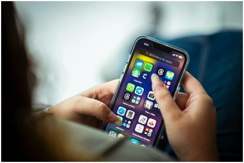 Close-up of a woman holding a smartphone displayin