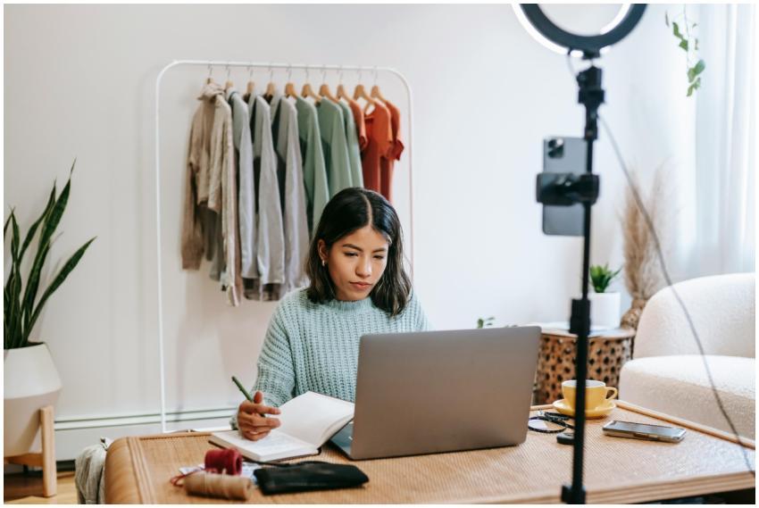Focused young woman working on laptop in home offi