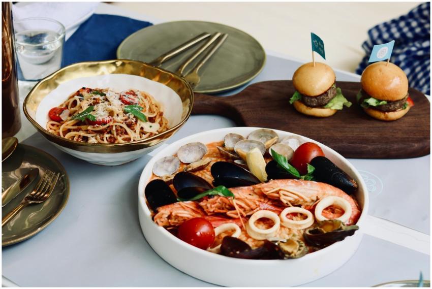 Delicious seafood and pasta dish with mini burgers