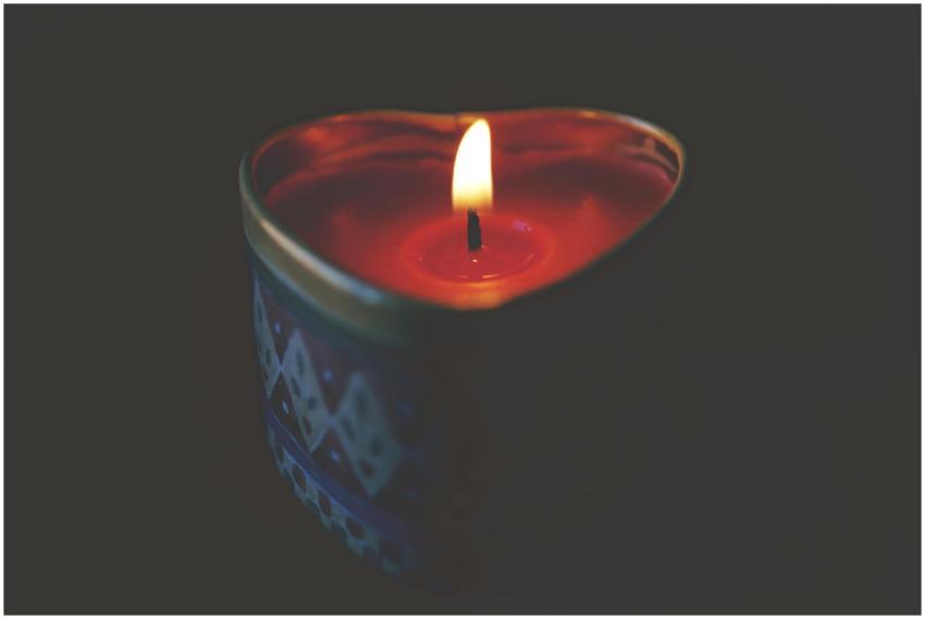 Heart-shaped candle with warm, glowing flame creat