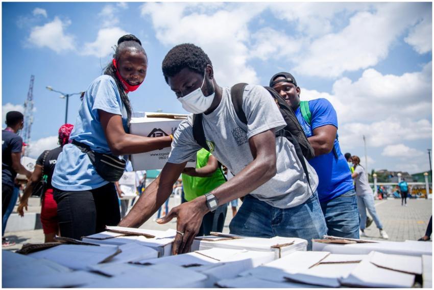 Volunteers distribute aid packages during a charit