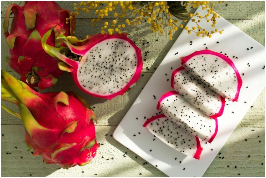 Vibrant dragon fruit slices on wood showcase tropi