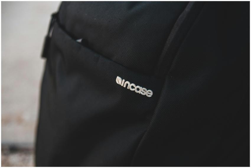 Minimalist close-up of a black backpack featuring