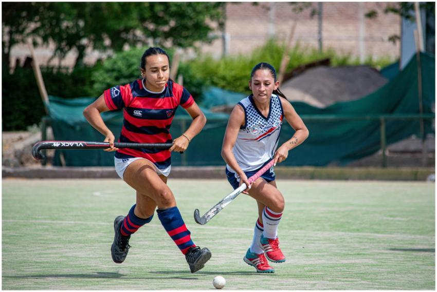 Two female athletes compete fiercely in an outdoor