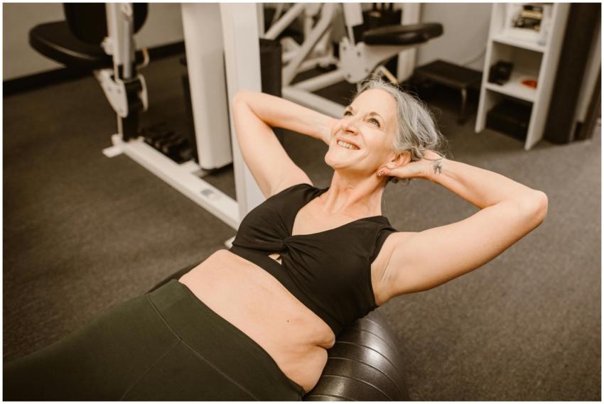 Elderly woman with gray hair smiling while exercis