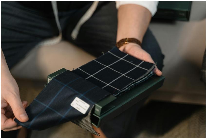 Tailor hands showcasing checkered fabric swatches