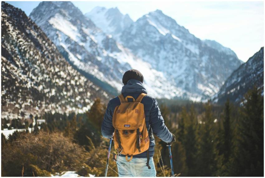 A lone hiker with a backpack explores a scenic win