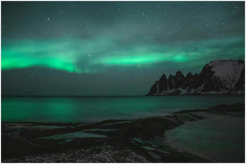 Breathtaking view of aurora borealis over calm sea