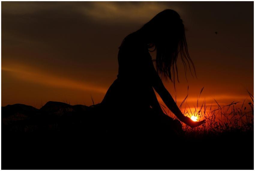 Artistic silhouette of a woman at sunset, capturin