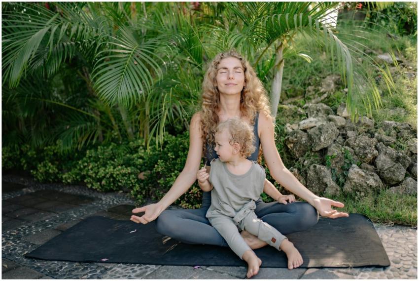 Full body happy relaxed mother sitting with eyes c