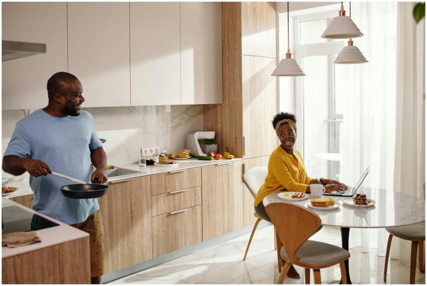 A couple enjoys their morning routine in a bright,