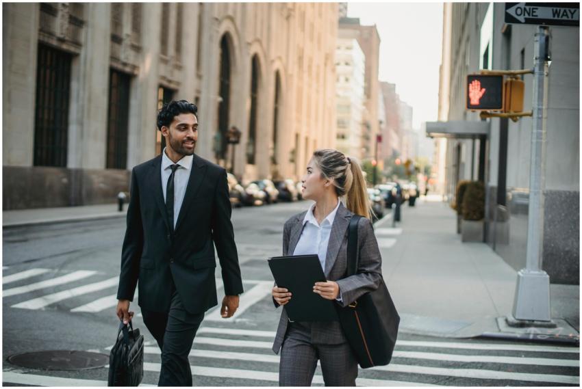 Two professionals in business attire discussing on