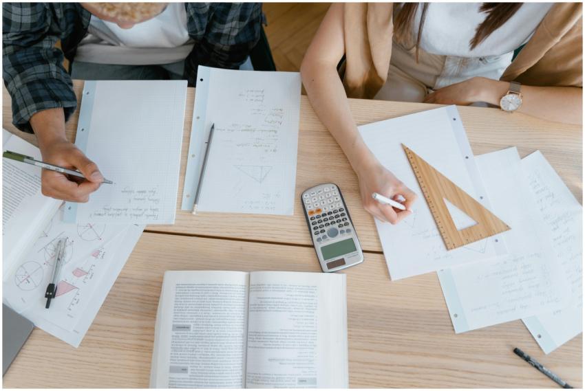 Top view of students working on math homework with