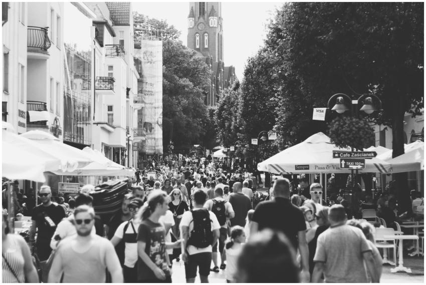A black and white photo capturing a busy street fi