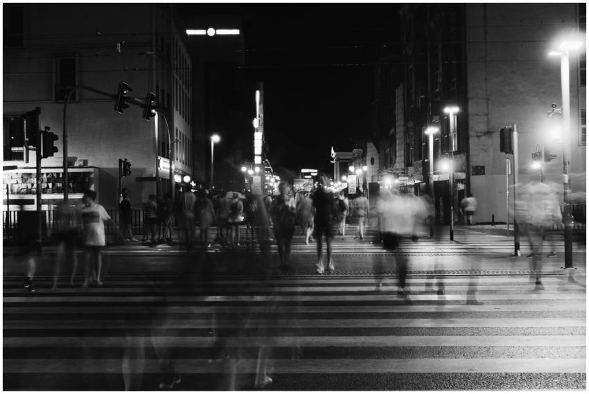 A bustling nighttime city scene with blurred pedes