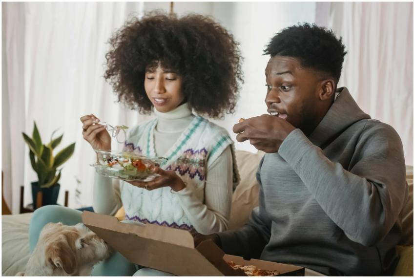 Positive young hungry African American couple with