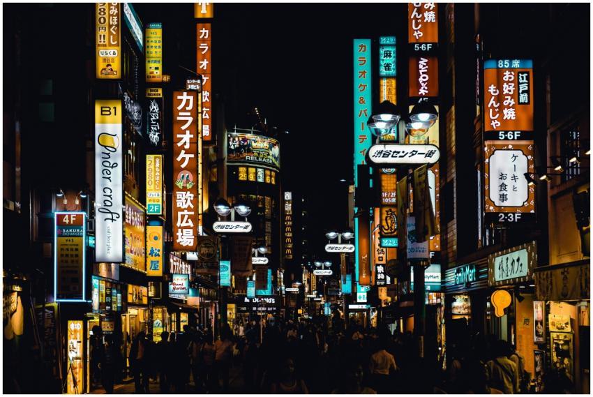 Bustling Shibuya street at night with bright neon