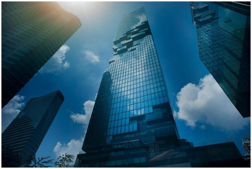 Dramatic view of modern skyscrapers amidst clouds