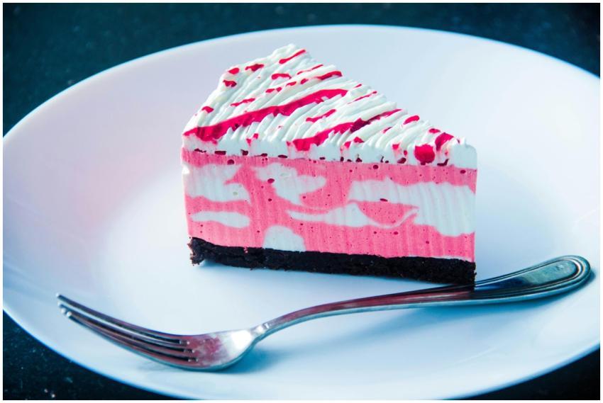 Close-up of a vibrant raspberry cream cake slice w