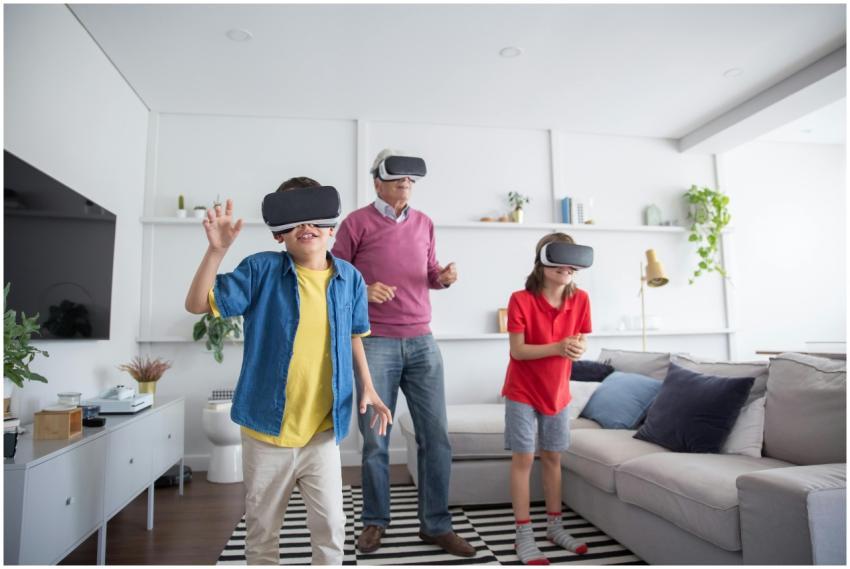 Three people using VR headsets in a living room, h