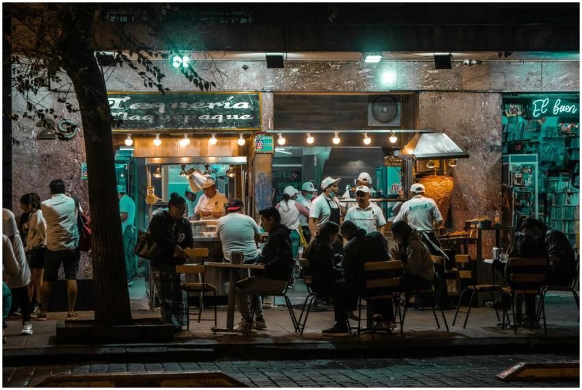 Crowded urban street restaurant at night, capturin