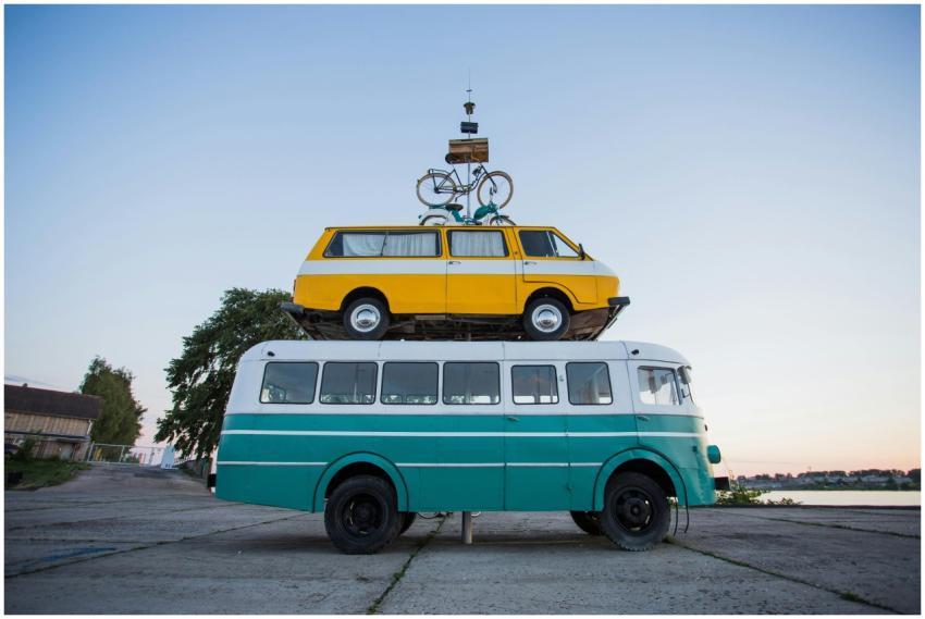 Creative outdoor sculpture featuring a van stacked