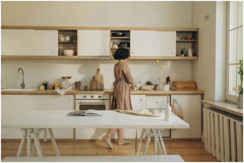A woman casually cooking in a minimalist kitchen w