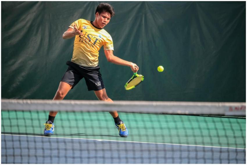 Male tennis player in action on an outdoor court,