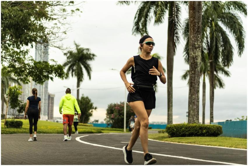 Woman jogging in a tropical park in Panama City on