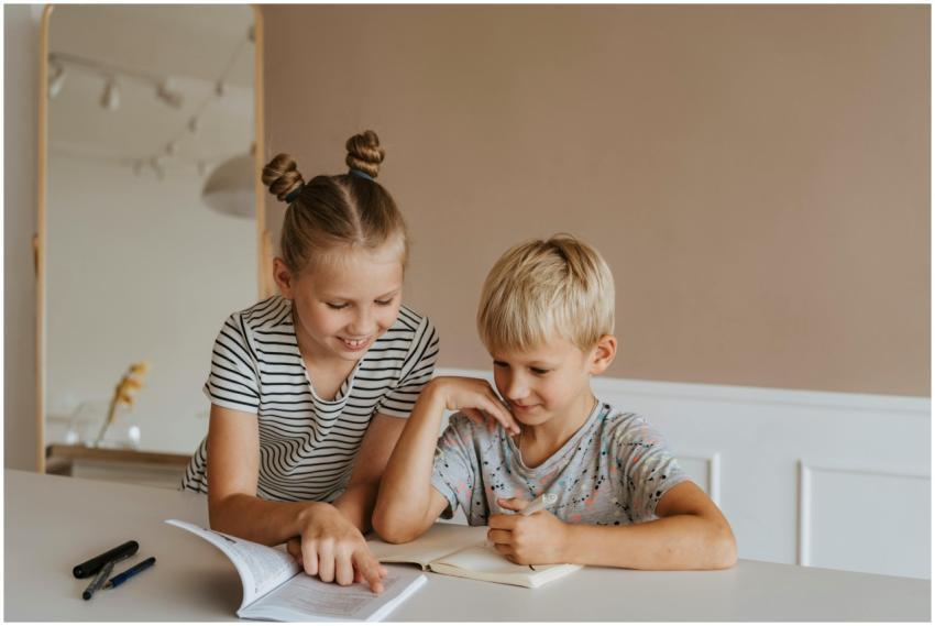 Two kids studying together at home, focusing on a