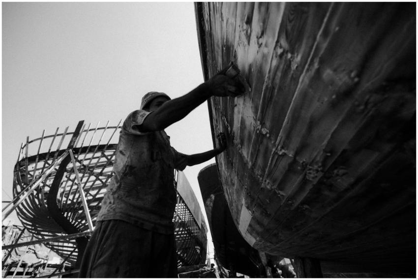 A worker repairs a boat in the shipyard of Damiett