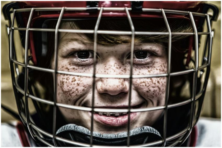 A vibrant close-up of a young ice hockey player sm