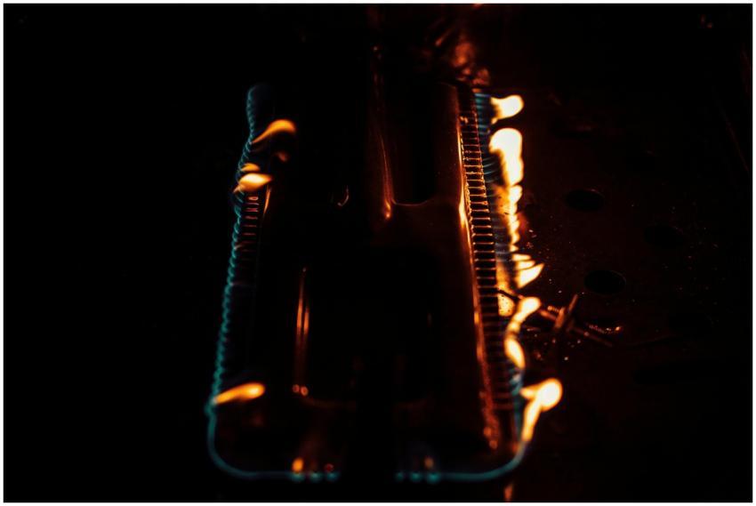 Close-up of flames on a gas burner. Dark and inten