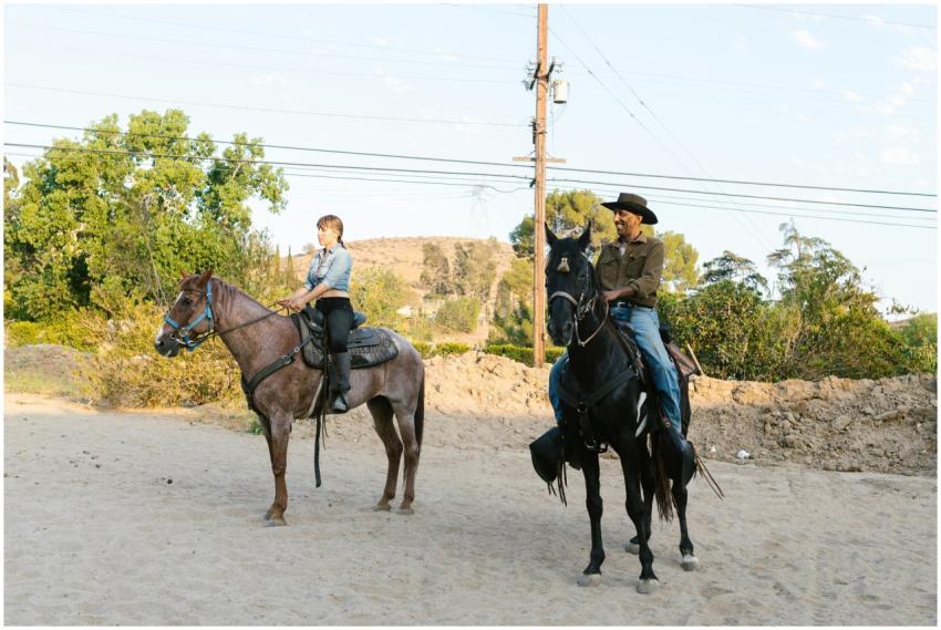 Two people riding horses outdoors, showcasing eque