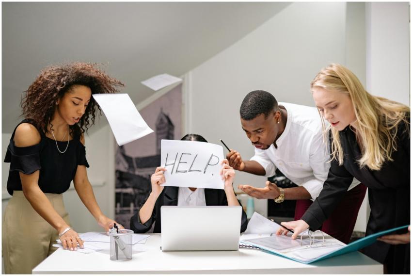 Team of stressed colleagues in an office dealing w