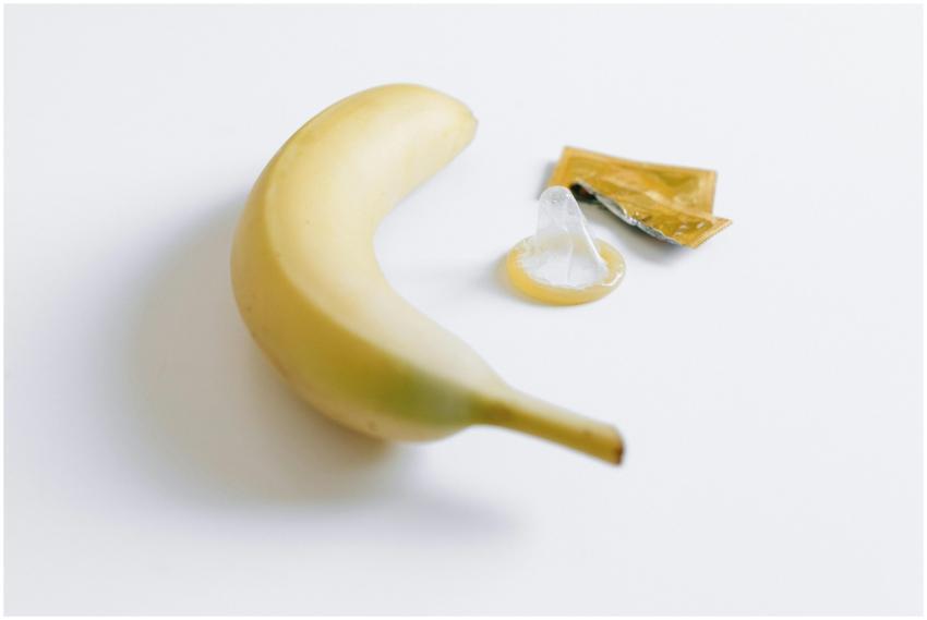 Conceptual image featuring a banana and a condom o