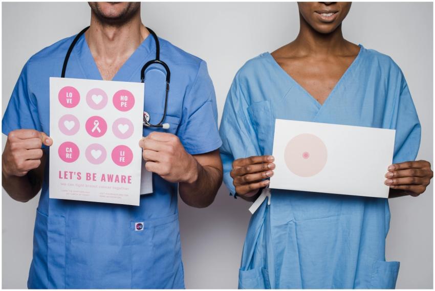 Two healthcare workers holding breast cancer aware