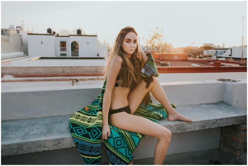 A woman in swimwear poses with a stylish look on a