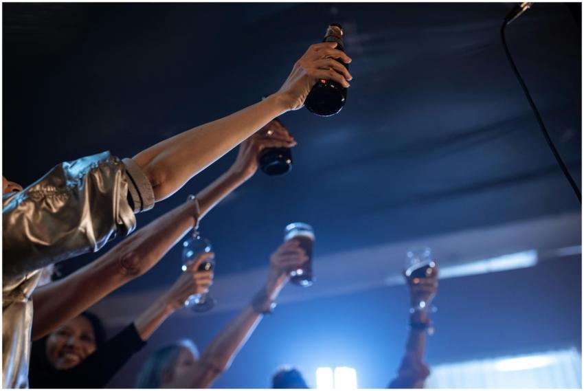 Joyful gathering at a bar with people raising drin
