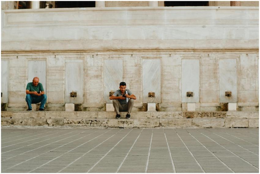 Two men sitting by marble wall in İstanbul, Türkiy