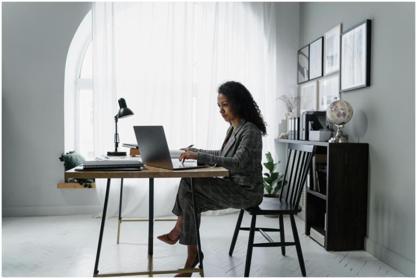 Businesswoman using a laptop at a stylish desk, fo